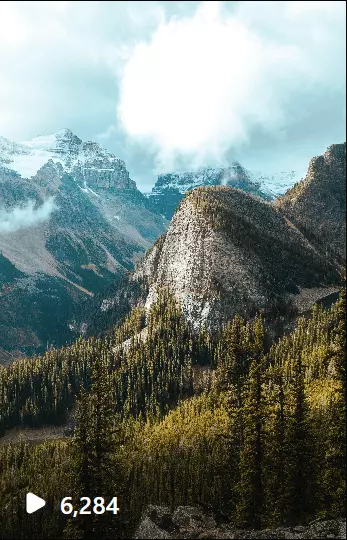 a view of a mountain range with trees in the foreground in Banff National Park