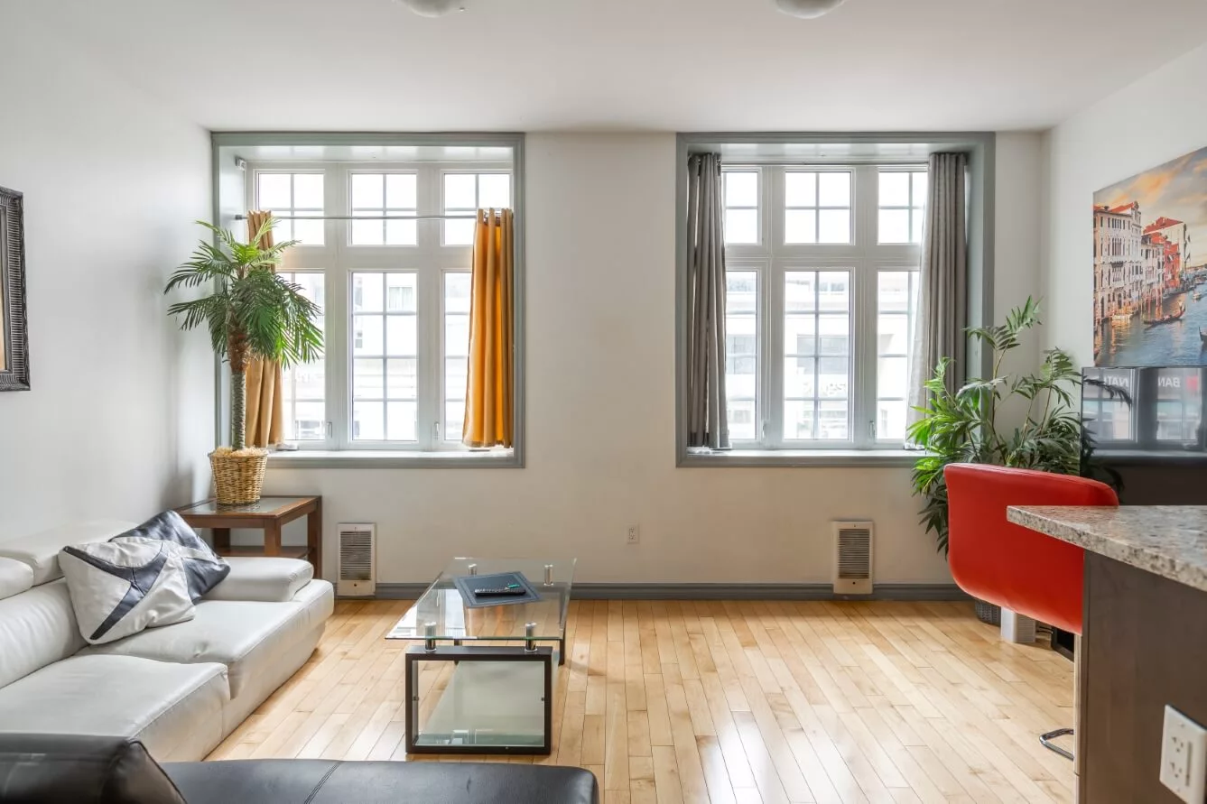 a living room filled with furniture and a large window. One of the units of Suitestay Apartments Hotel